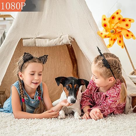 Two girls and a small dog lying on a fluffy rug in front of a play tent 3