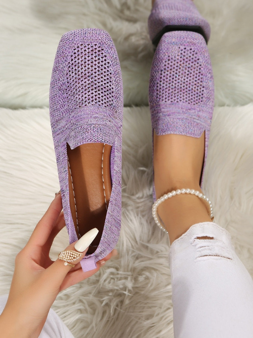 Top view of lilac knit slip-ons with perforated toes and a brown insole.