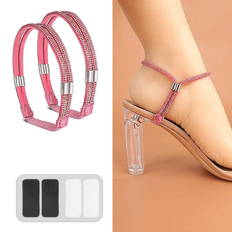 Pair of hot pink crystal-covered elastic shoe straps with adhesive pads worn on a clear-heeled sandal.