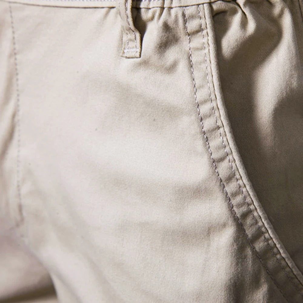 Close-up of the stitched side pocket seam and a belt loop on beige fabric 3