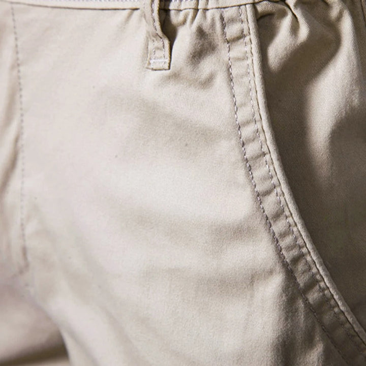 Close-up of the stitched side pocket seam and a belt loop on beige fabric 3