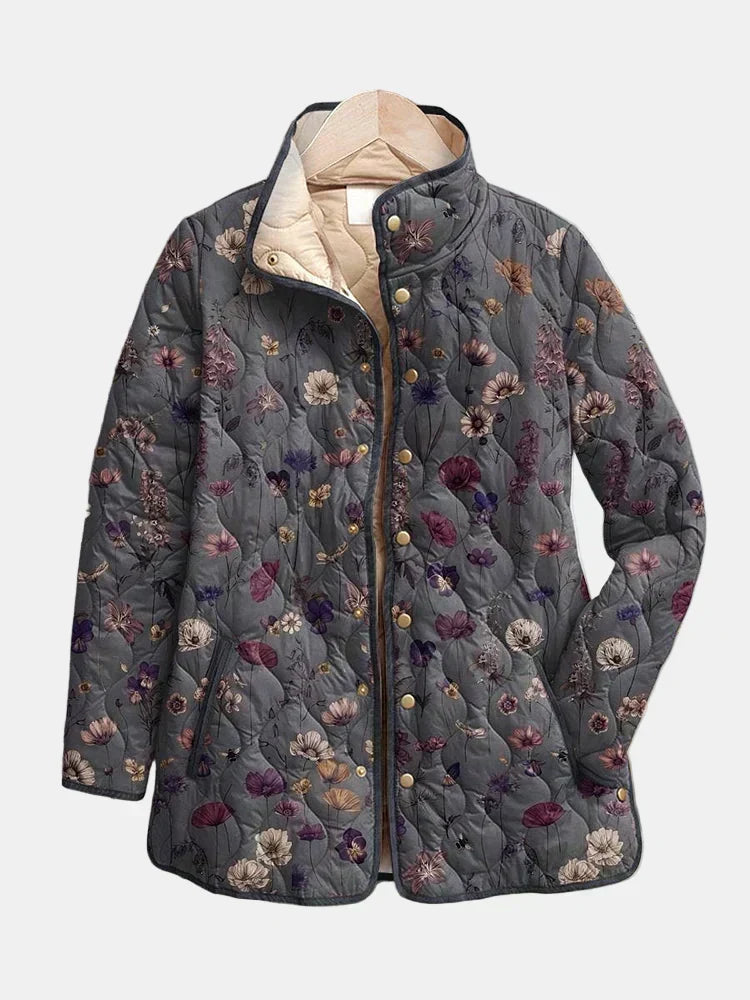 Grey quilted jacket with a purple and cream floral print and gold snap buttons, another view. 2