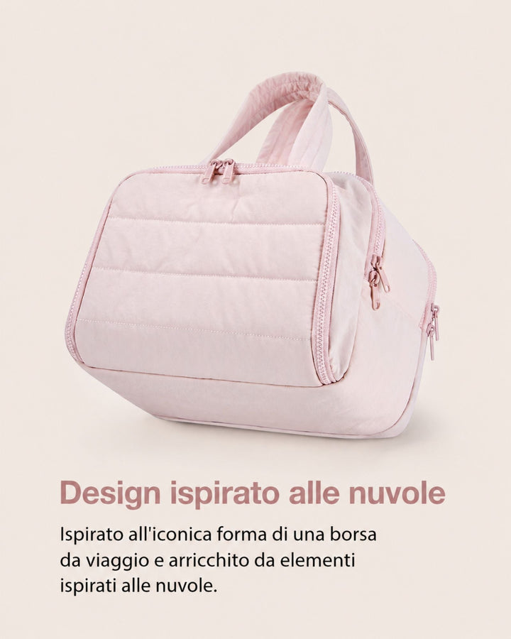 Pink quilted bag angled to show padded front panel, rounded body and pink zipper pulls along the side.
