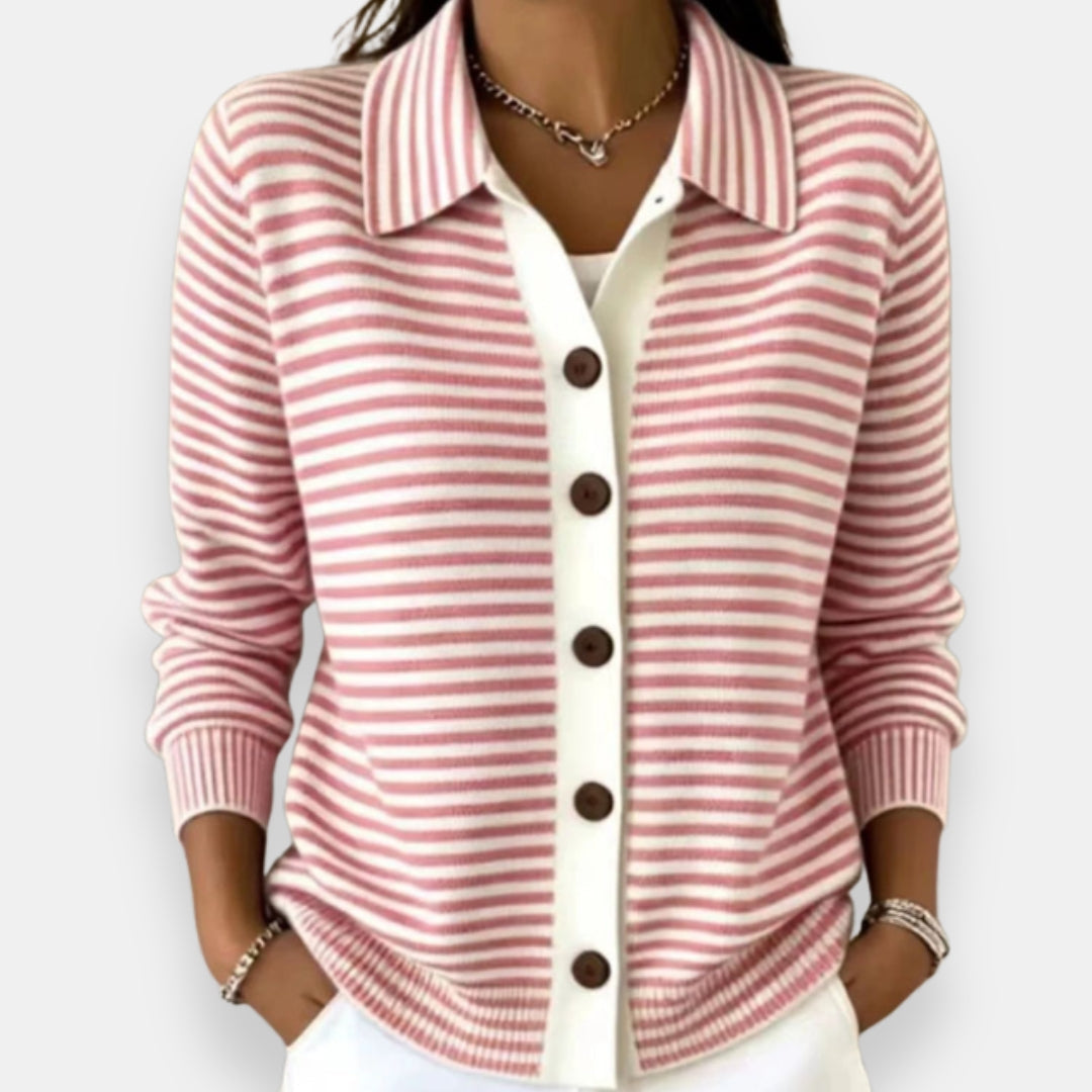 Woman wearing the collared cardigan in pink and white stripes with brown buttons, white placket, ribbed cuffs, hands in pockets. 4