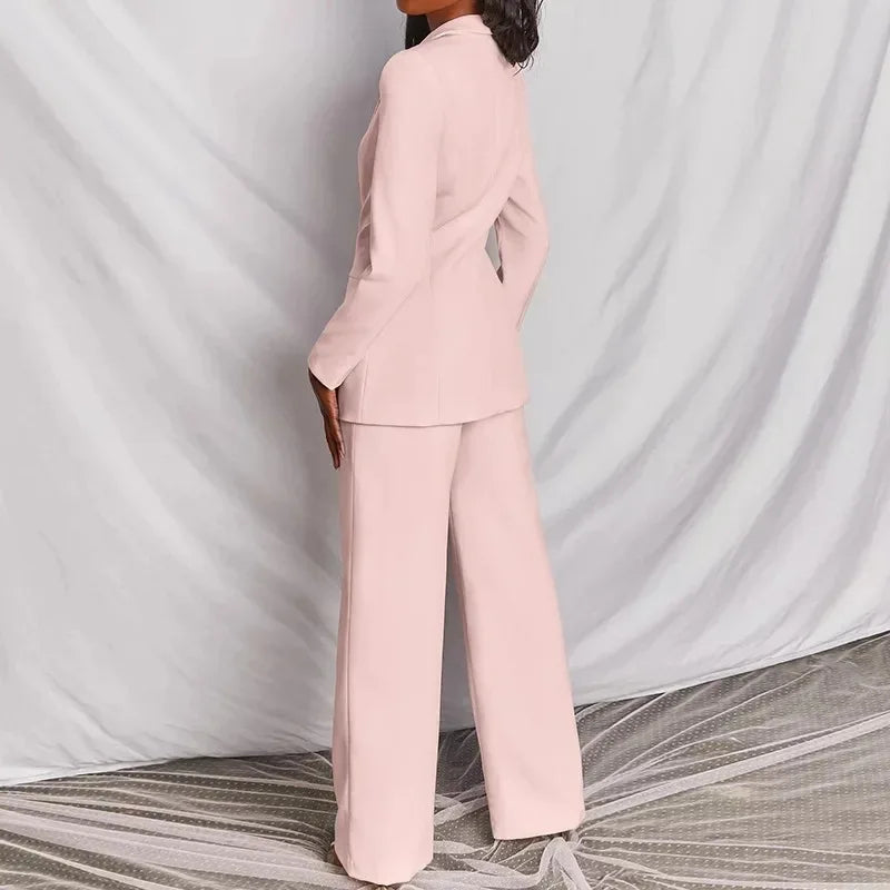 Back view of the light pink suit showing the blazer's fitted shape and long wide pants 7
