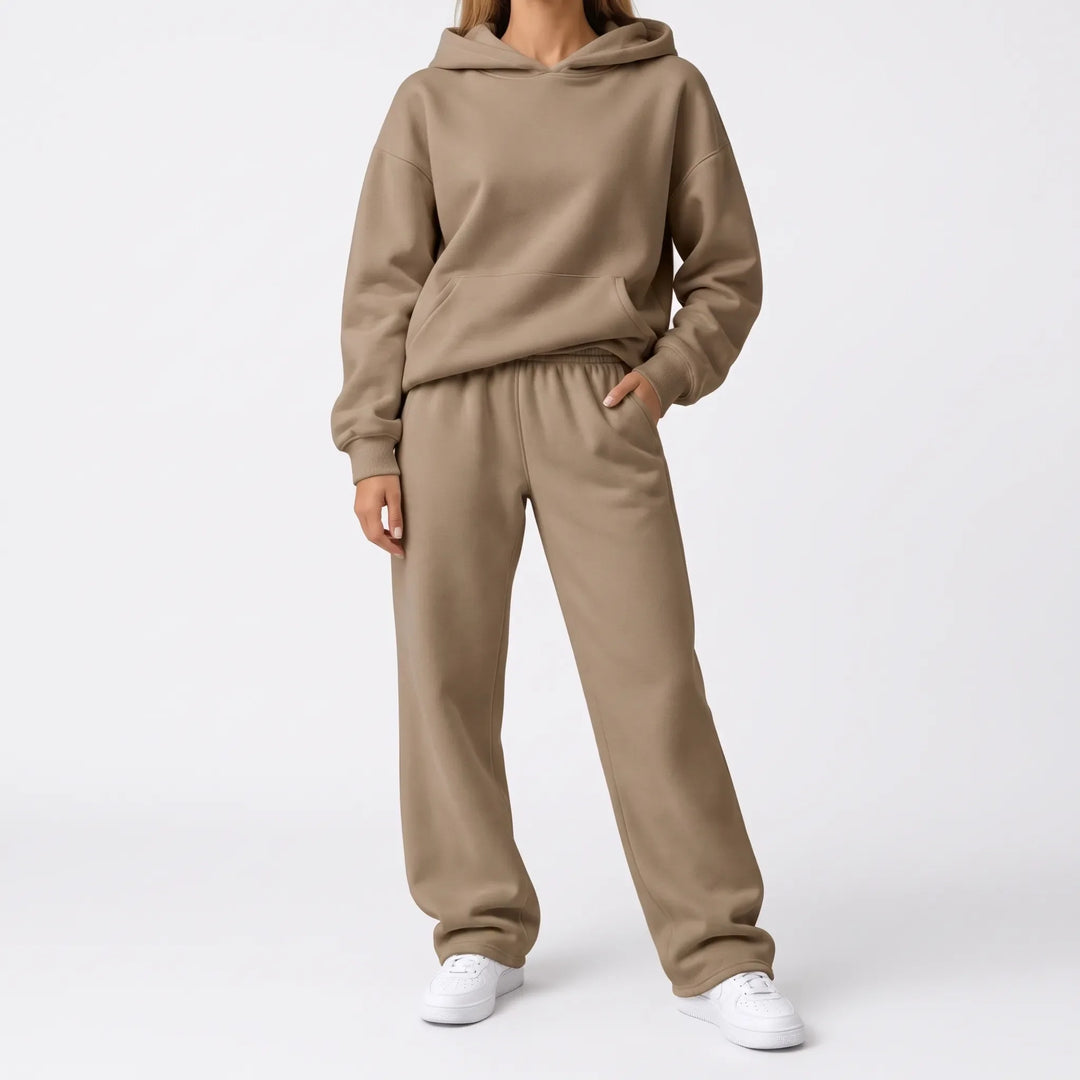 Full-length view of the tan hoodie and wide-leg sweatpants on a model with white sneakers 7