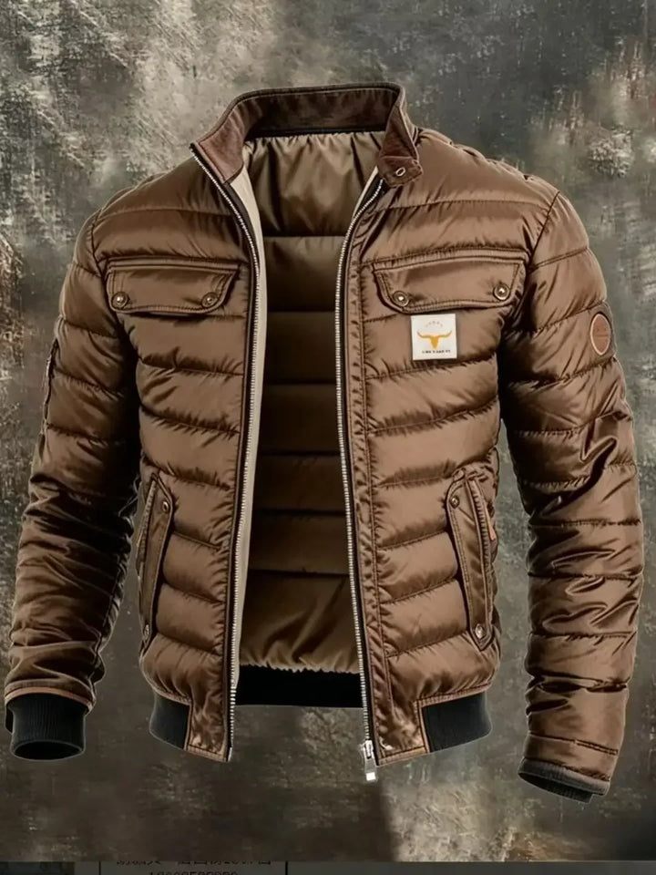 Close crop of the brown quilted jacket, showing its glossy horizontal quilting and chest and hip pockets 7