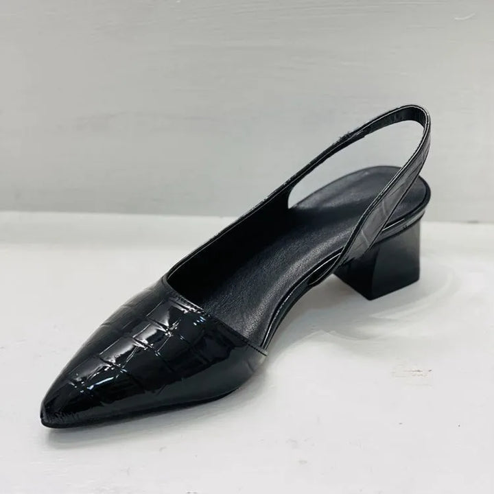 Black croc-embossed slingback seen from the heel side, showing the strap, padded insole and block heel 7