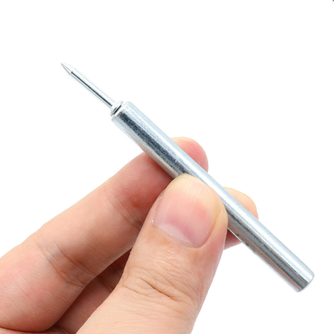 Hand holding the metal sleeve tool with a nail seated in its end.
