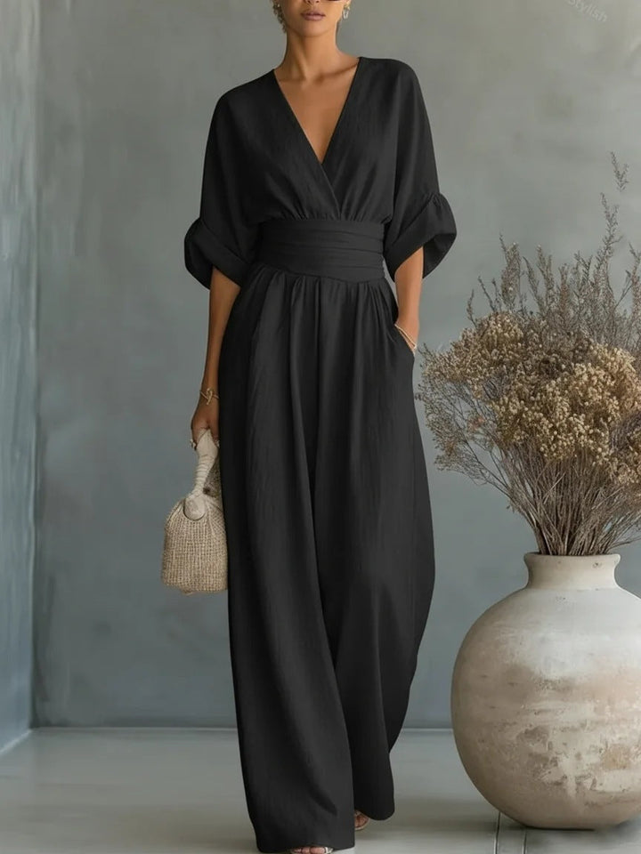 Black women's jumpsuit with a plunging V-neck and wide legs.