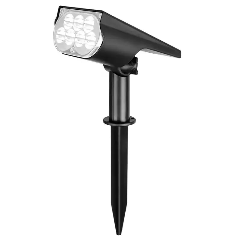 Black solar spotlight on a ground stake showing the LED cluster on the front.