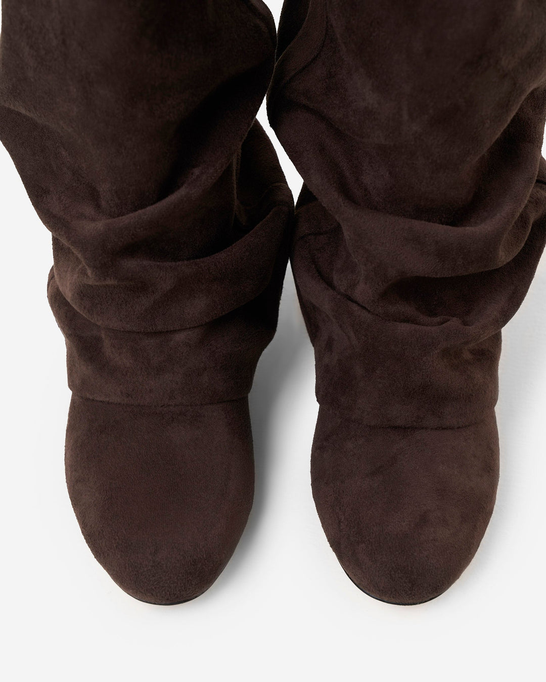 Top-down view of the pair's rounded toes and gathered folds of the dark brown suede-look shafts, 5