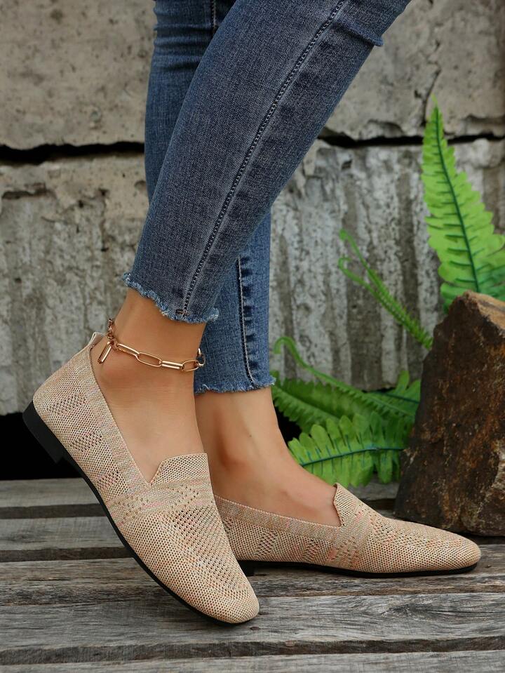 Beige knit slip-on flats with perforated mesh pattern and thin black sole, another view.