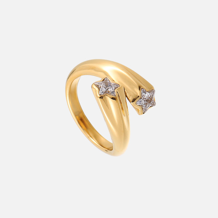 Gold open-band star ring seen from a three-quarter angle, showing both clear star crystals and the smooth curved band. 2