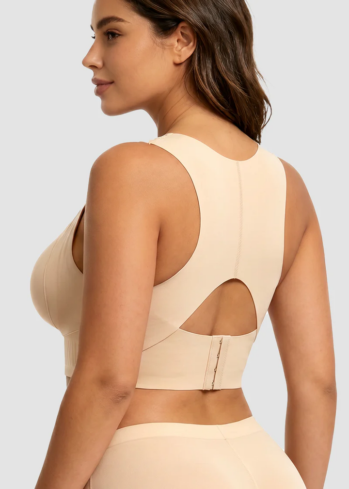 Back view of the beige bra showing the racerback shape, center seam, keyhole cutout and hook closure.