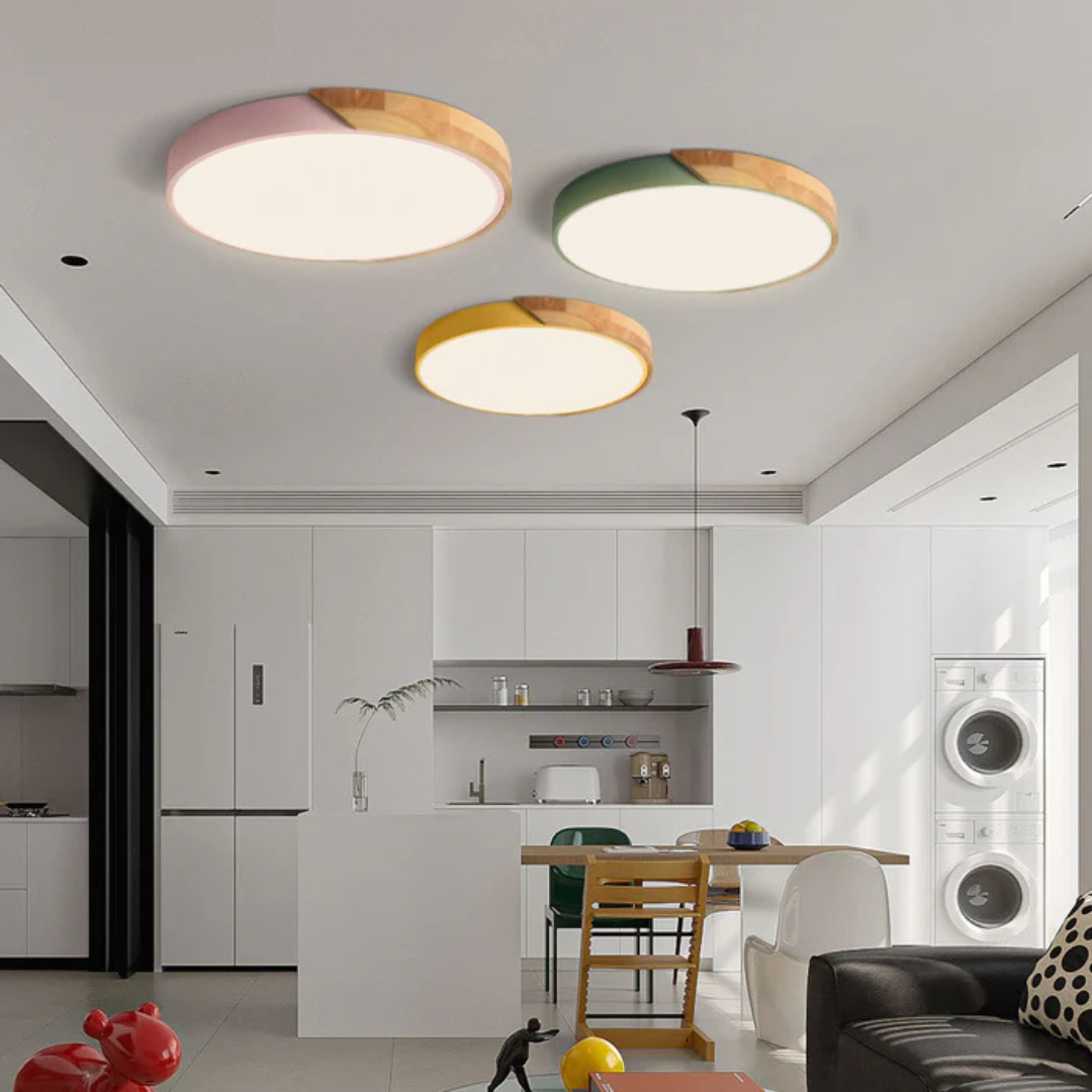 Delos Scandi Wood Ceiling Light with round flush-mount lights in pink, green and yellow in a bright white kitchen.
