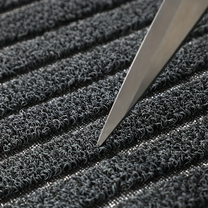 Grey striped doormat detail showing dense curly loops in rows.