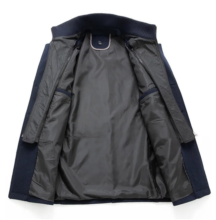 Navy overcoat opened flat to show the dark quilted lining, inner zip layer and ribbed collar 8
