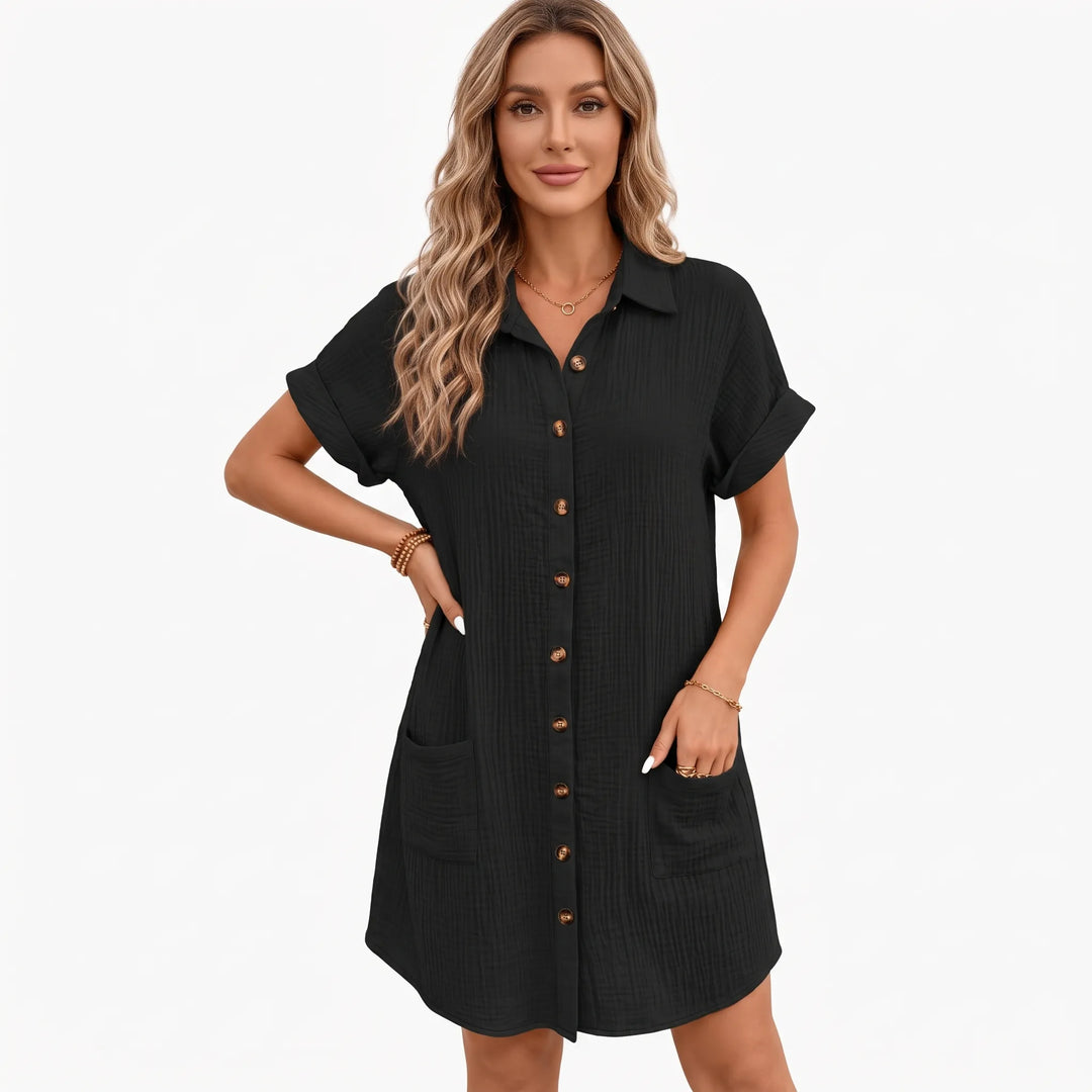 Black crinkled shirt dress on a model against a white backdrop, hand in side pocket 8