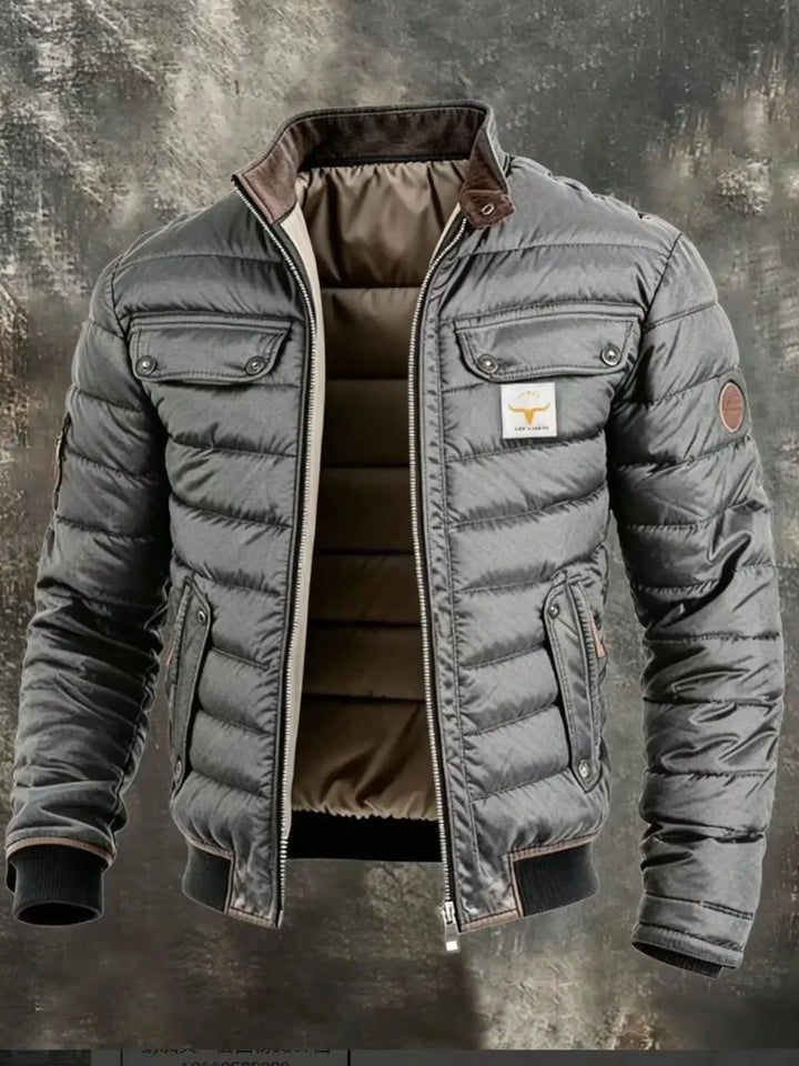 Close crop of the gray quilted jacket, showing stand collar, zipper, pockets and sleeve patch 8