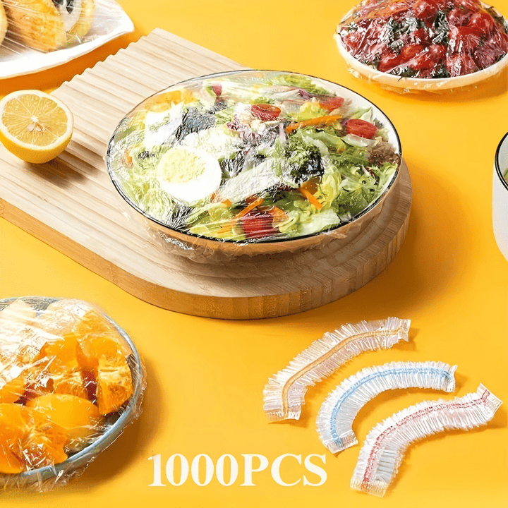 Another view of a covered salad bowl, orange slices and tomatoes