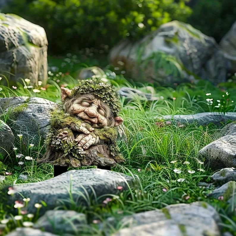 Fairy Tale Acrylic Garden Stake with a sleeping troll among rocks detail