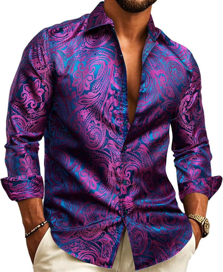 Model wearing the long-sleeve shirt in magenta paisley jacquard over a blue base, open collar, cream trousers.