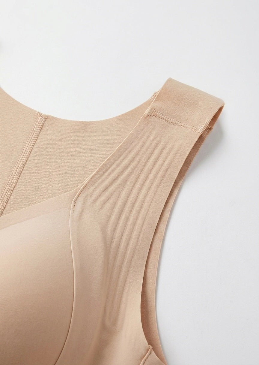 Close-up of the beige bra's wide shoulder strap with ribbed texture, stitching and smooth cup edge.