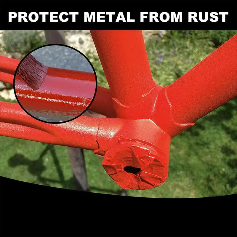 Rust remover and metal restorer another view showing a red-coated bicycle frame on grass.