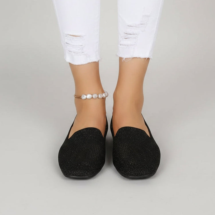 Black glittery knit square-toe flats, front view.