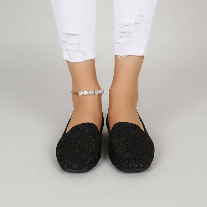 Black glittery knit square-toe flats, front view.