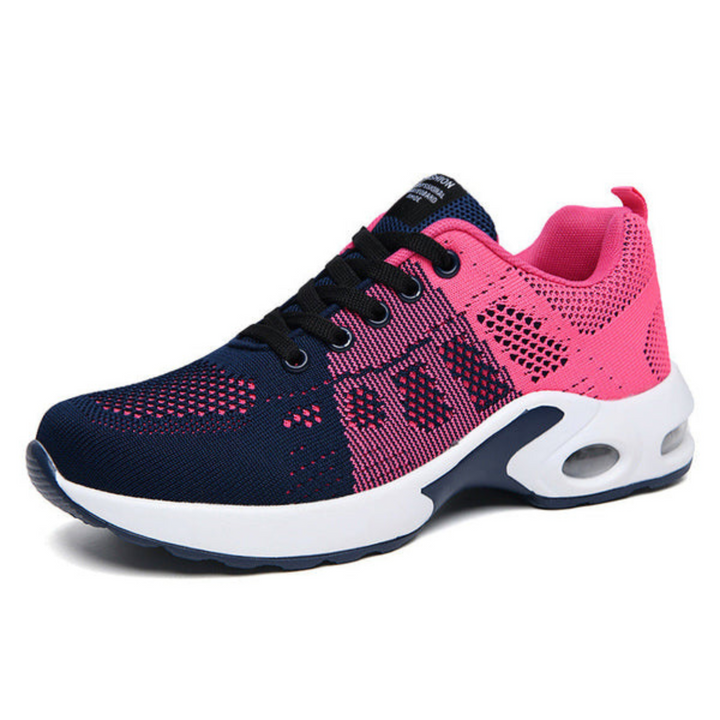 Side view of a navy and hot pink color-block mesh sneaker with black laces and a white cushioned sole. 6