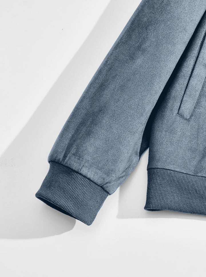 Flat lay of the blue jacket's sleeve with ribbed cuff and ribbed hem beside the side pocket 9