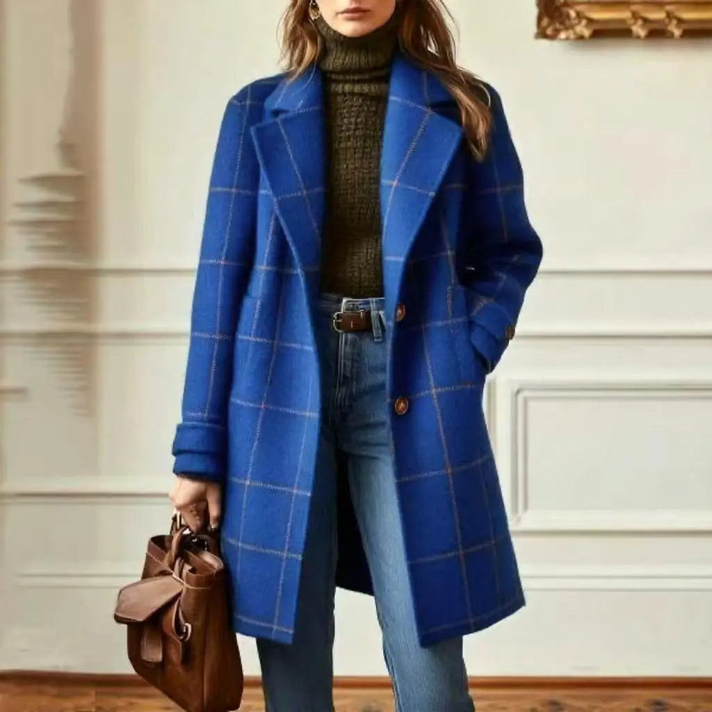 Woman wearing the bright royal blue checked coat with a hand in pocket, holding a brown tote 9