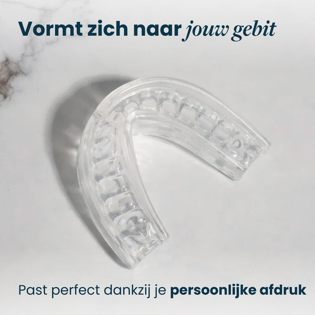 Top view of the clear recovery mouthpiece on marble showing tooth impressions in its inner channel.