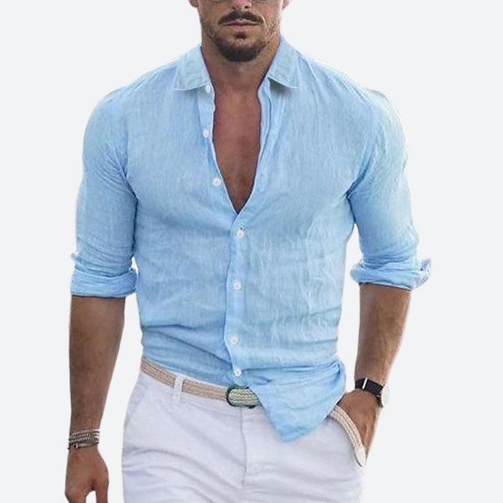 Men's linen shirt in light sky blue with an open collar and rolled sleeves.