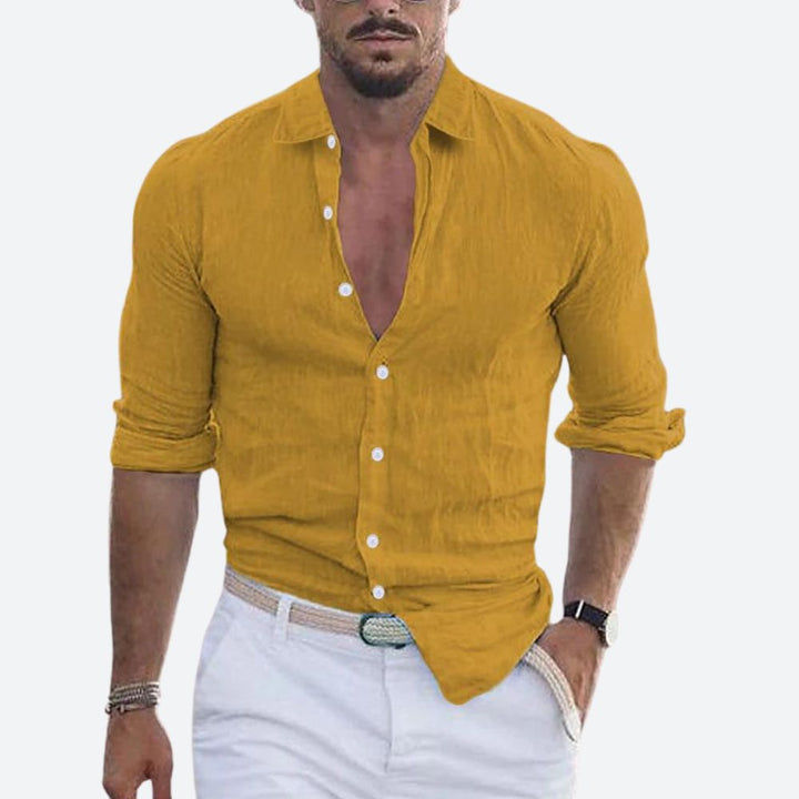 Men's linen shirt in mustard yellow with an open collar and rolled sleeves.