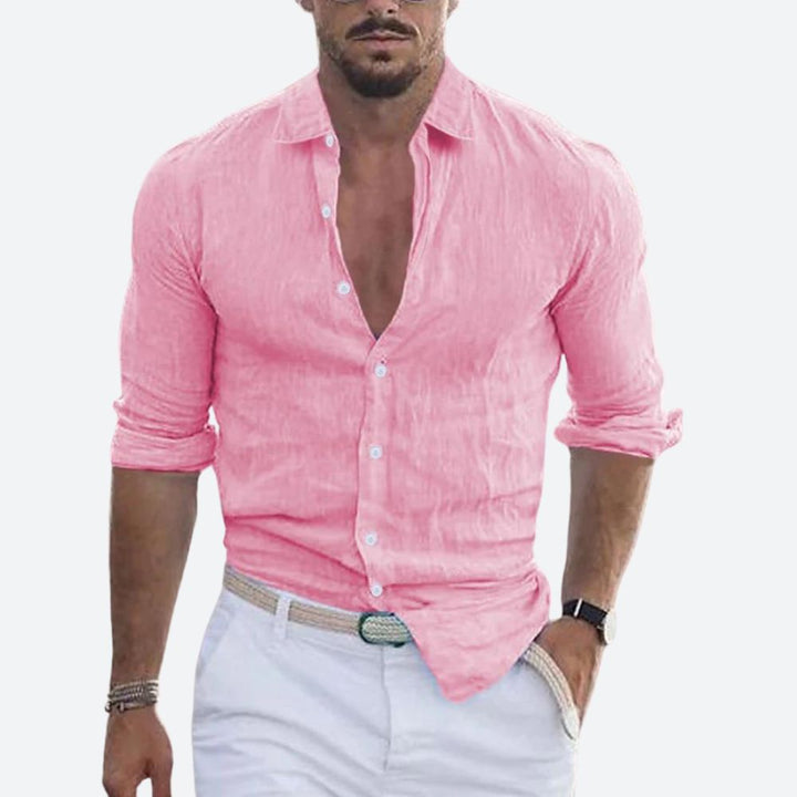 Men's linen shirt in bright pink with an open collar and rolled sleeves.