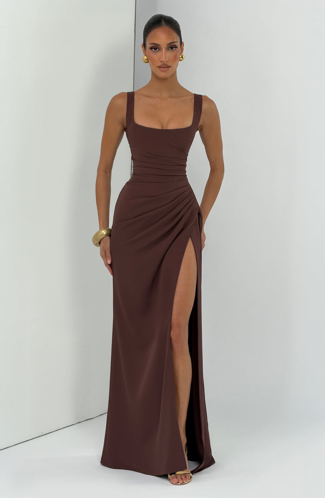 Brown Camille Maxi Dress full-length view on a model with the high slit visible.
