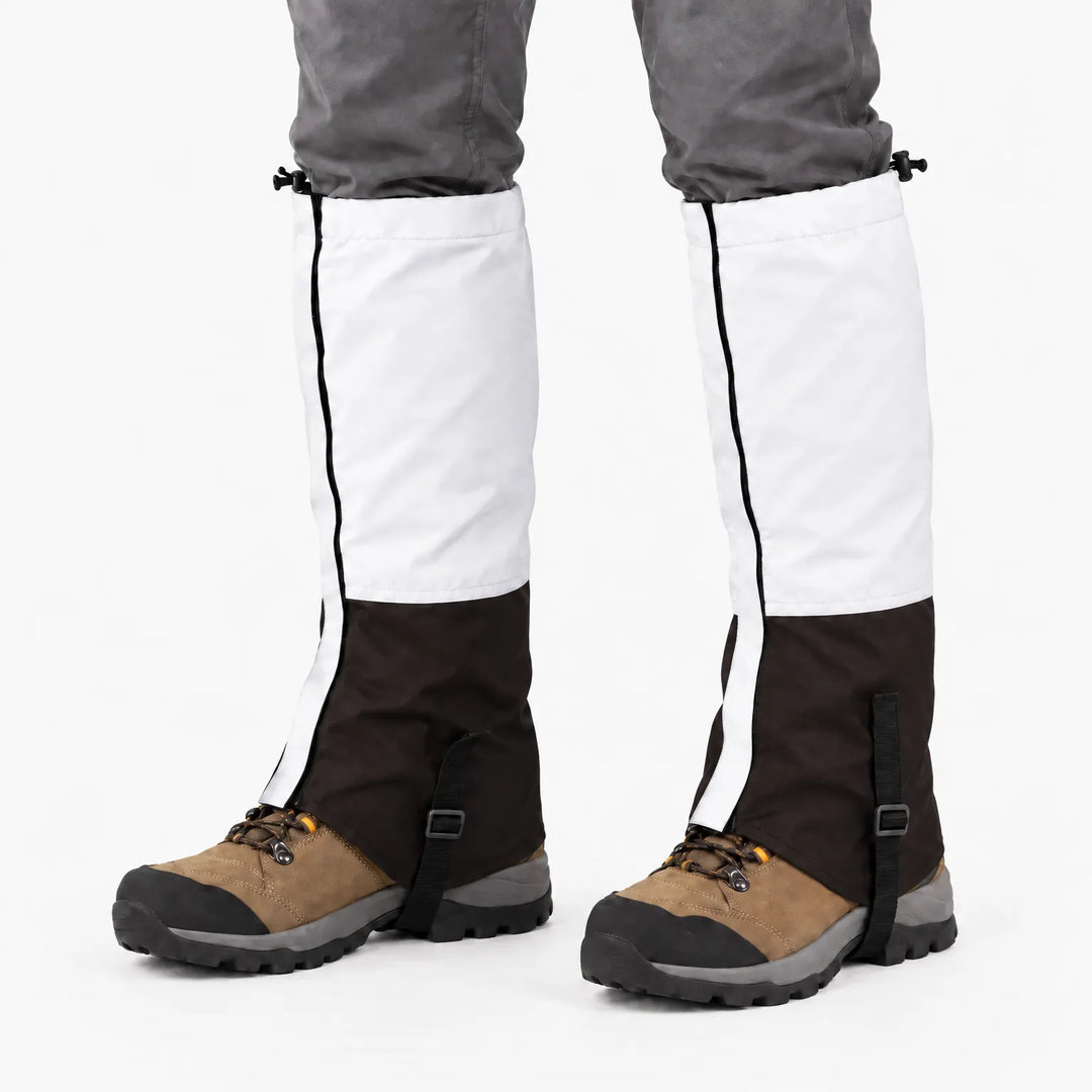 White upper and dark brown lower gaiters worn over hiking boots, front view showing the side seam and boot strap. 7