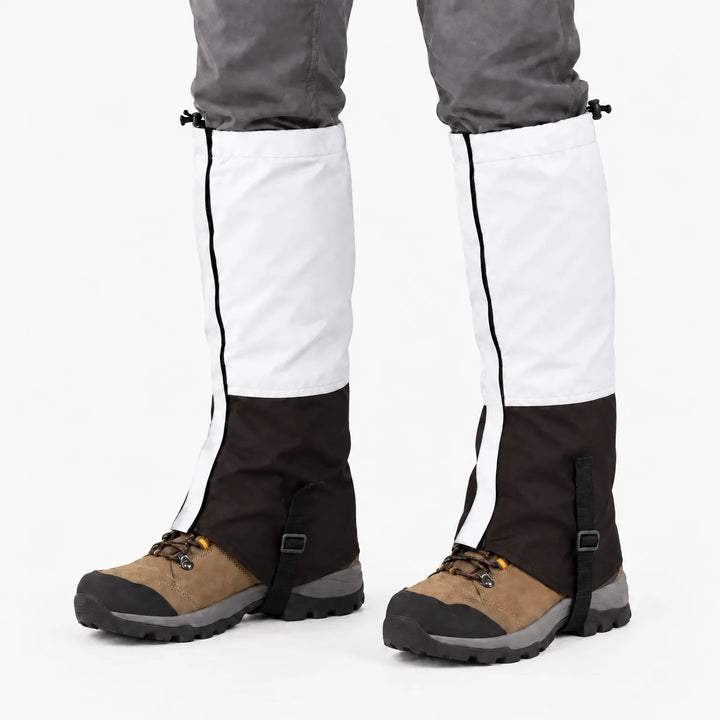 White upper and dark brown lower gaiters worn over hiking boots, front view showing the side seam and boot strap. 7