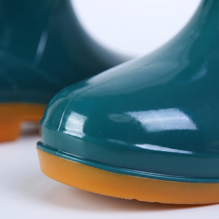 Close-up of a glossy teal boot toe and orange sole, showing the smooth shiny finish and seam detail. 5