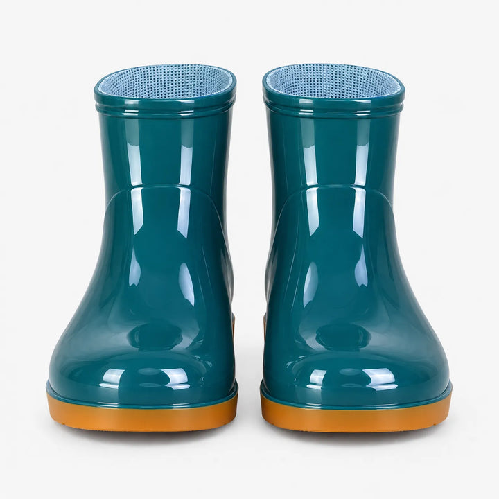Front view of a pair of glossy teal ankle boots with orange soles and light blue mesh lining inside. 7
