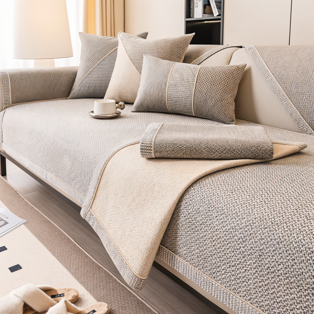 Beige-gray cover with a folded section revealing the plush tan lining, a folded piece on the seat, and pillows. 3