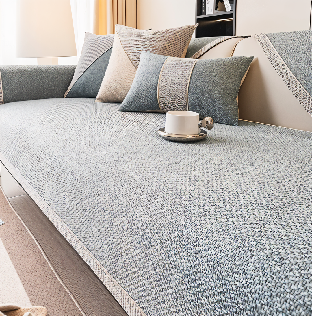 Slate gray version of the cover on a sofa, with coordinating pillows and a white cup on the seat. 6