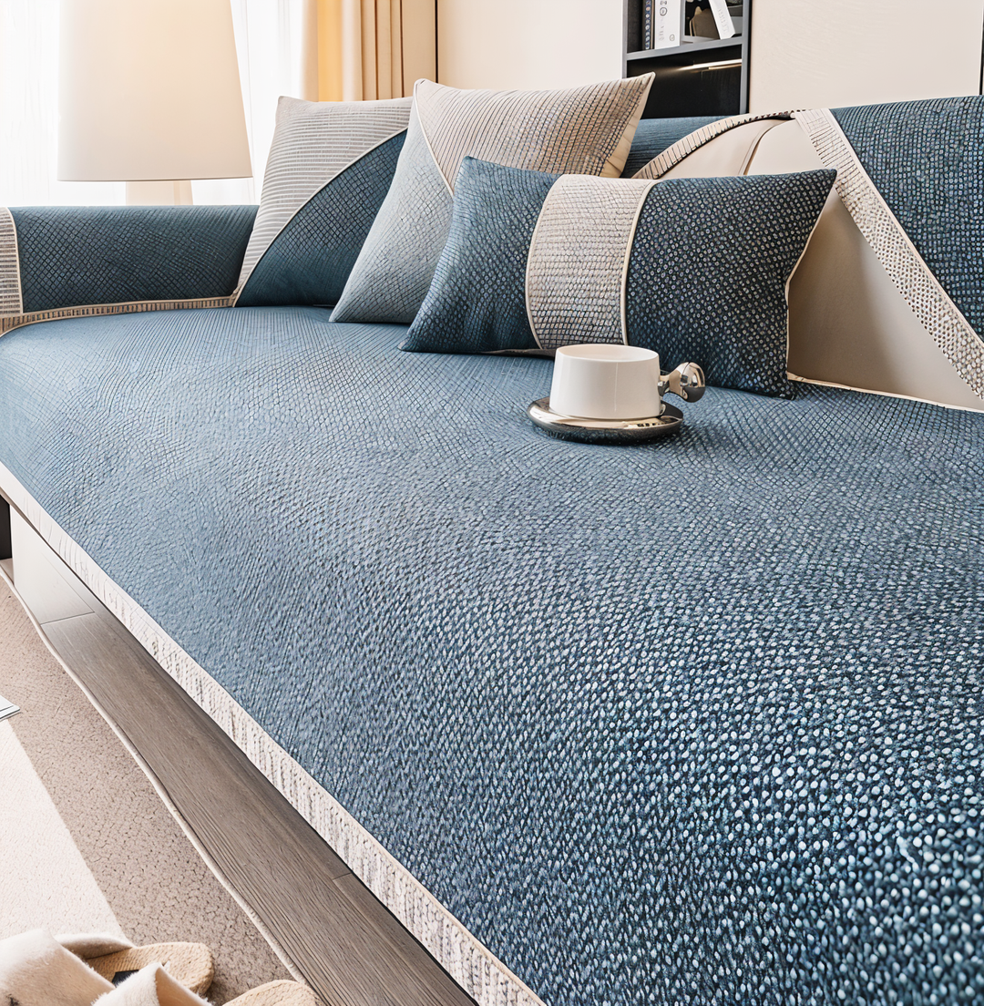 Deep blue version of the cover on a sofa, with matching blue pillows and a white cup on the seat. 8