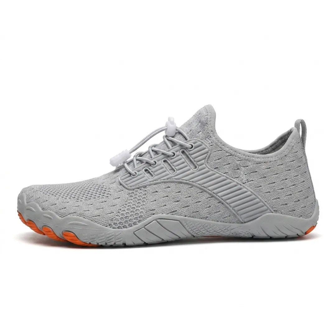 Side view of a light gray knit barefoot sneaker with orange toe tips and a gray sole.
