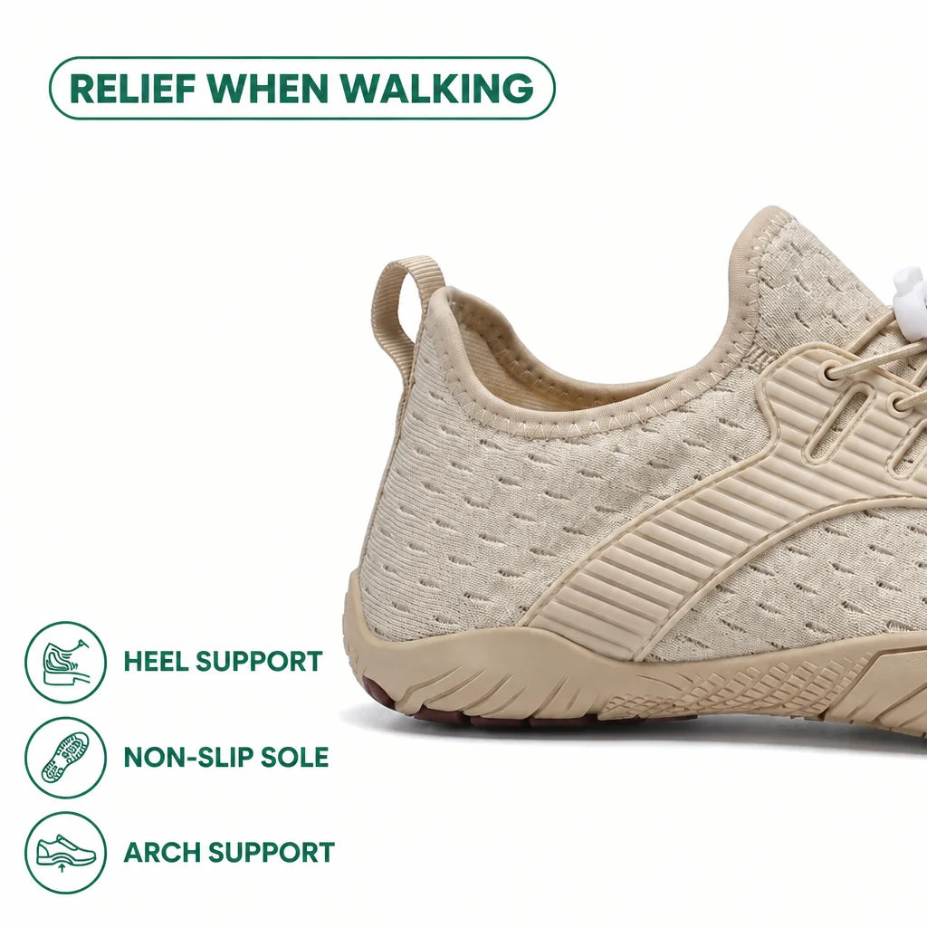 Close-up of the heel of a beige sneaker, with icons for heel support, non-slip sole and arch support.