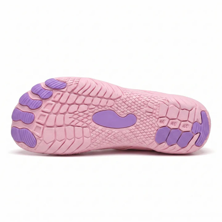 Underside of a pink sneaker showing the textured tread with purple toe pods and a purple center patch. 31