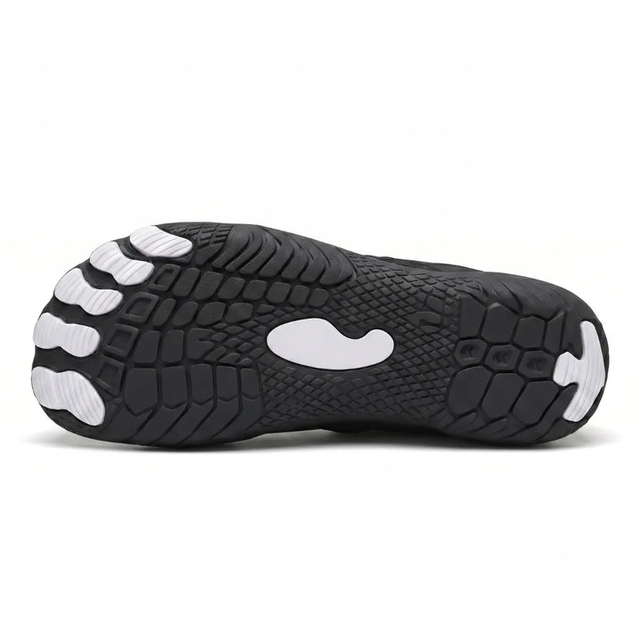 Underside of a black sneaker showing the textured tread with white toe pods and a white center patch. 38